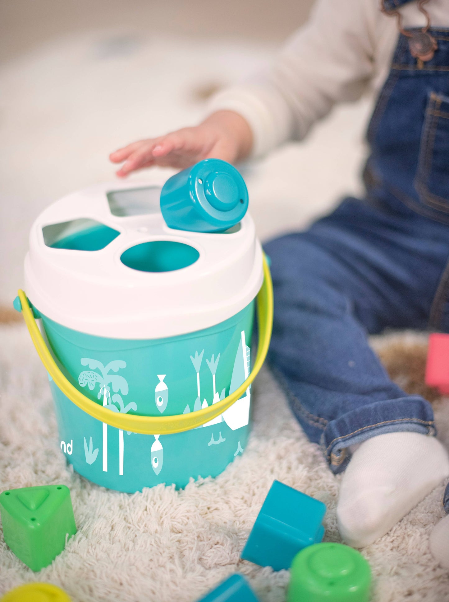 Miniland Educational - Feel to Learn: Turquoise shape sorting bucket