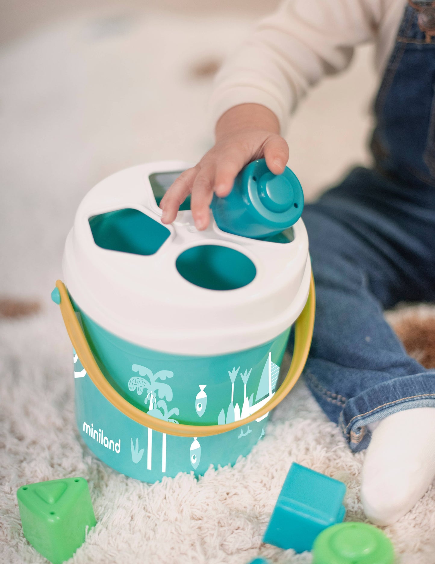 Miniland Educational - Feel to Learn: Turquoise shape sorting bucket